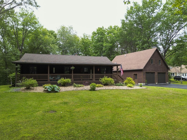 509 Upper Guinea Rd, Lebanon, ME 04027 - log cabin with covered porch, a garage, a front yard, driveway, and an outdoor structure