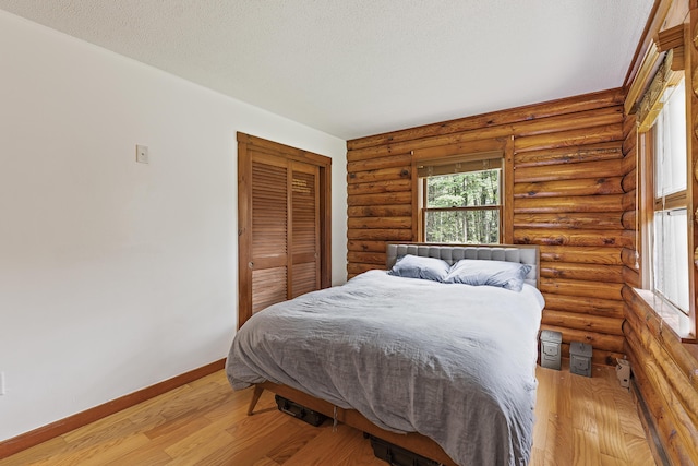 509 Upper Guinea Rd, Lebanon, ME 04027 - bedroom featuring multiple windows, light wood-style flooring, and a closet