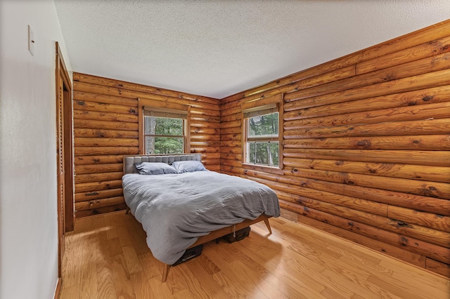 509 Upper Guinea Rd, Lebanon, ME 04027 - bedroom featuring a textured ceiling and wood finished floors