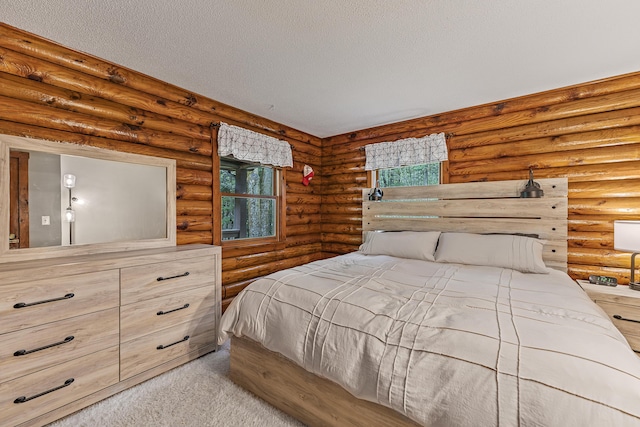 509 Upper Guinea Rd, Lebanon, ME 04027 - carpeted bedroom with multiple windows, a textured ceiling, and rustic walls