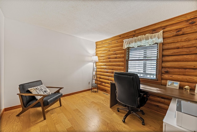 509 Upper Guinea Rd, Lebanon, ME 04027 - office featuring log walls, a textured ceiling, and light wood-style flooring