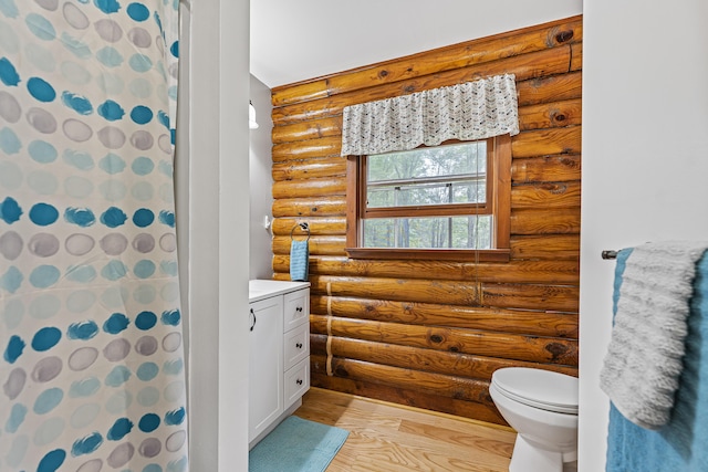 509 Upper Guinea Rd, Lebanon, ME 04027 - bathroom featuring rustic walls, wood finished floors, vanity, and a shower with curtain