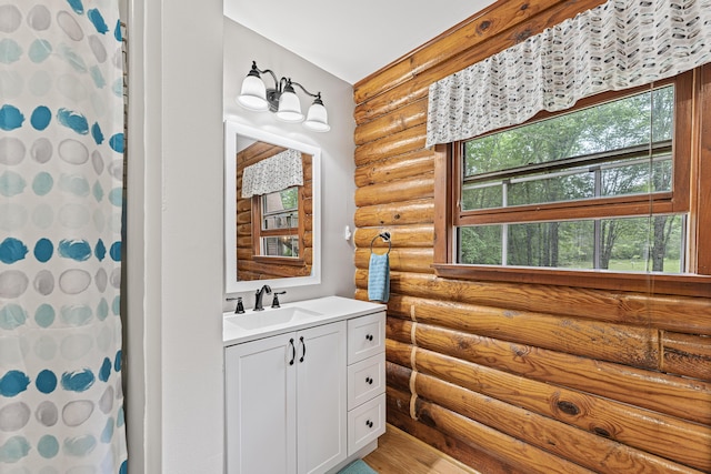 509 Upper Guinea Rd, Lebanon, ME 04027 - bathroom with rustic walls, vanity, wood finished floors, and curtained shower