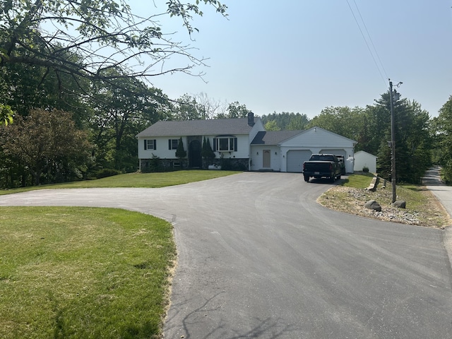 8 Camp Rd, Hartford, ME 04220 - view of front facade featuring asphalt driveway, a front lawn, an attached garage, and a chimney