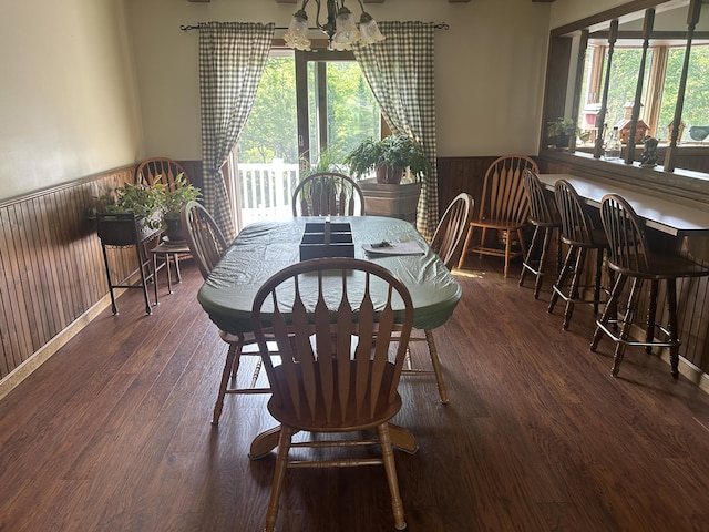 8 Camp Rd, Hartford, ME 04220 - dining room with wainscoting, wooden walls, a chandelier, and wood finished floors