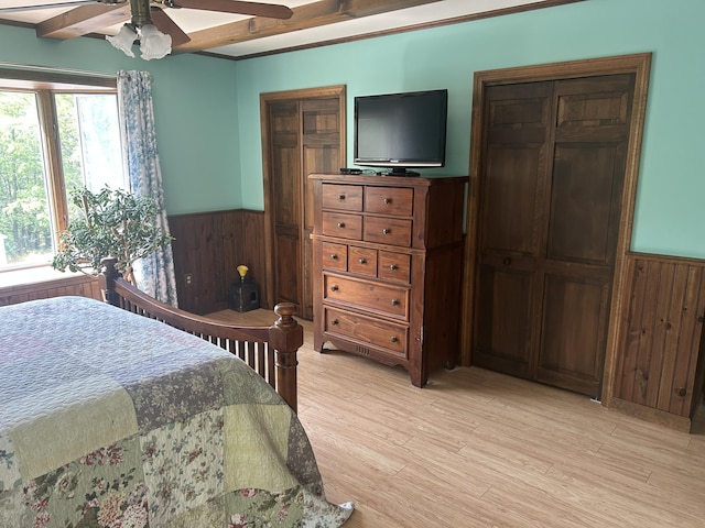 8 Camp Rd, Hartford, ME 04220 - bedroom with a wainscoted wall, wood walls, light wood-style floors, and a ceiling fan