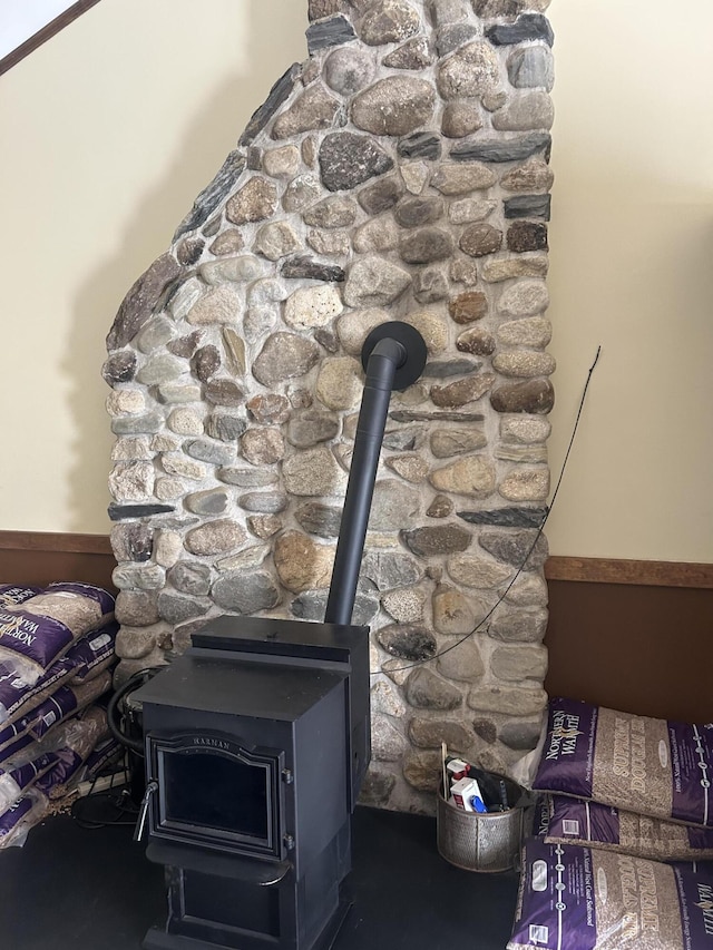8 Camp Rd, Hartford, ME 04220 - detailed view of a wood stove and a wainscoted wall