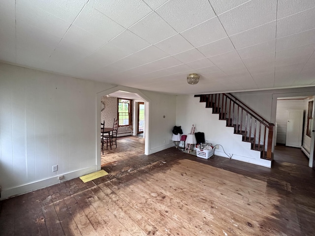 18 Kimball Rd, Bridgton, ME 04009 - unfurnished living room with hardwood / wood-style floors, arched walkways, stairway, and baseboards