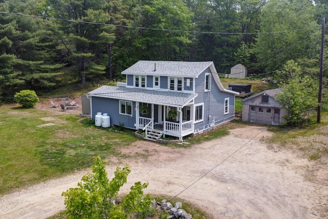 133 Middlesex Rd, Topsham, ME 04086 - view of front of property with an outdoor structure, a forest view, a porch, driveway, and a shingled roof