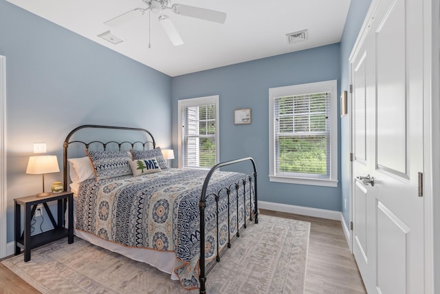 46 Patriot Way Unit 135, Arundel, ME 04046 - bedroom featuring baseboards, wood finished floors, and a ceiling fan