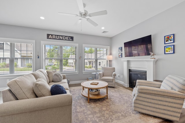 46 Patriot Way Unit 135, Arundel, ME 04046 - living room with baseboards, ceiling fan, recessed lighting, a glass covered fireplace, and wood finished floors