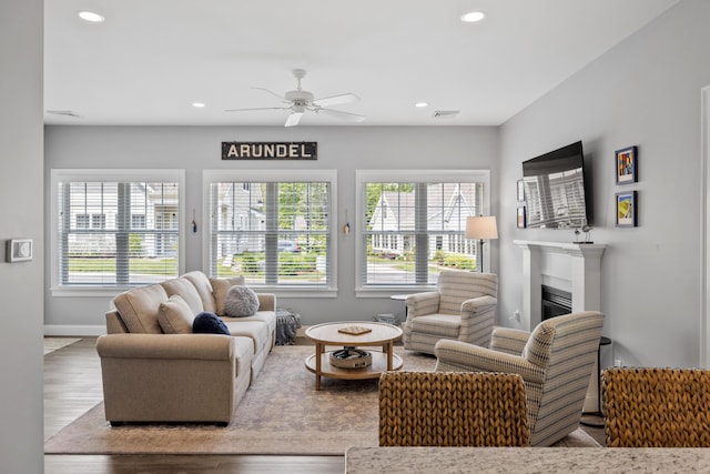 46 Patriot Way Unit 135, Arundel, ME 04046 - living area featuring ceiling fan, wood finished floors, a glass covered fireplace, recessed lighting, and baseboards