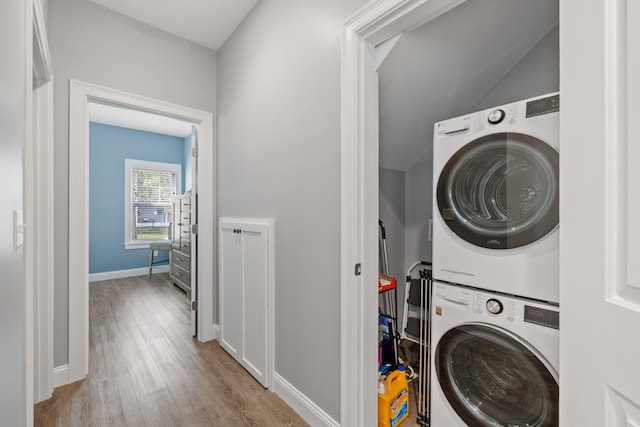 46 Patriot Way Unit 135, Arundel, ME 04046 - washroom featuring stacked washer and clothes dryer, wood finished floors, and baseboards
