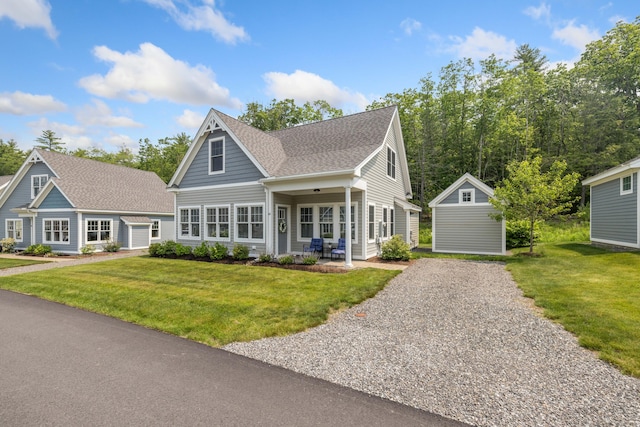 46 Patriot Way Unit 135, Arundel, ME 04046 - view of front of property featuring a front lawn, roof with shingles, and gravel driveway