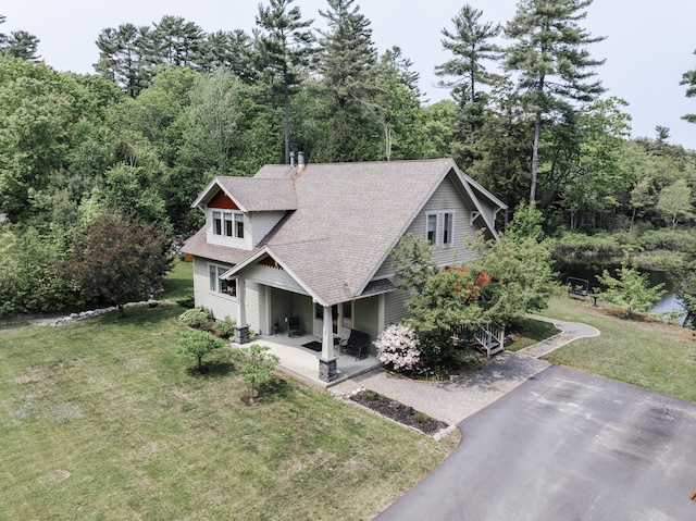 15 Brookview Dr, Bucksport, ME 04416 - view of front of property with roof with shingles, a front yard, and a patio area