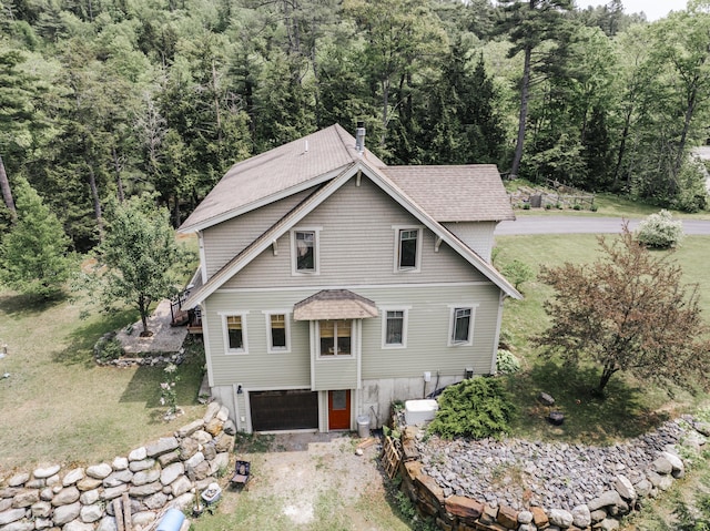 15 Brookview Dr, Bucksport, ME 04416 - view of front of property with a garage, a wooded view, a chimney, roof with shingles, and a front yard