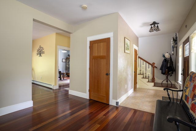 15 Brookview Dr, Bucksport, ME 04416 - foyer featuring baseboard heating, wood-type flooring, stairway, and baseboards