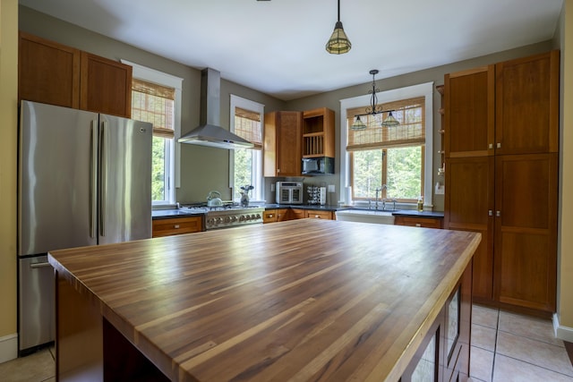 15 Brookview Dr, Bucksport, ME 04416 - kitchen featuring wall chimney range hood, freestanding refrigerator, wood counters, stove, and open shelves