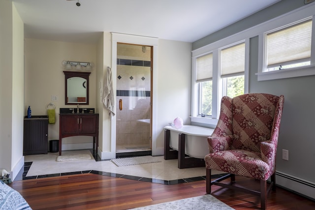 15 Brookview Dr, Bucksport, ME 04416 - living area featuring a baseboard radiator, baseboards, and wood finished floors