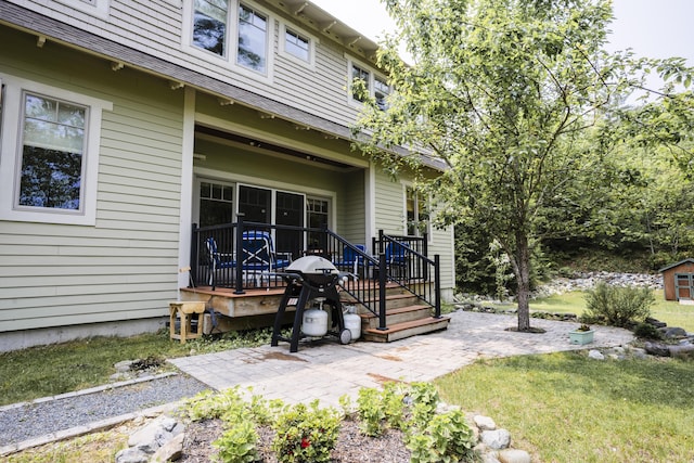 15 Brookview Dr, Bucksport, ME 04416 - view of side of home with a patio and a lawn