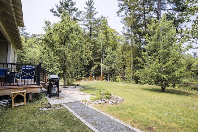 15 Brookview Dr, Bucksport, ME 04416 - view of grassy yard featuring a wooden deck and a patio