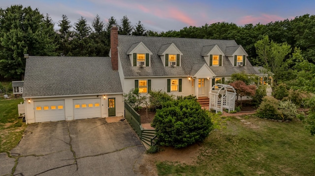 116 Point Rd, Acton, ME 04001 - view of front facade featuring driveway, a chimney, a garage, and a front yard
