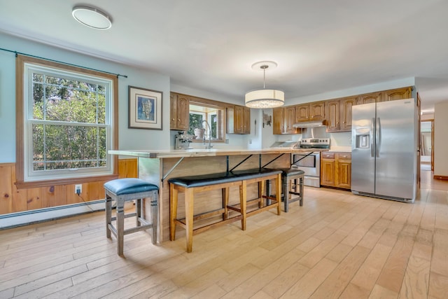116 Point Rd, Acton, ME 04001 - kitchen with appliances with stainless steel finishes, light countertops, light wood finished floors, and wainscoting