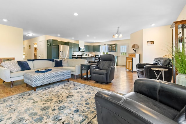 18 Fox Meade Ln, Searsmont, ME 04973 - living room featuring a chandelier, wood finished floors, and recessed lighting