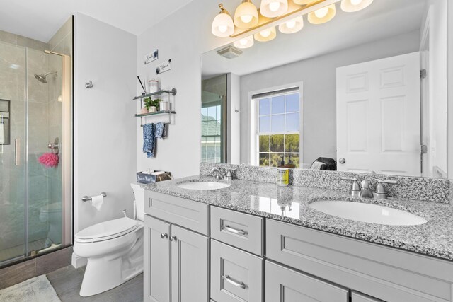 18 Fox Meade Ln, Searsmont, ME 04973 - full bathroom featuring double vanity, a stall shower, toilet, and tile patterned floors