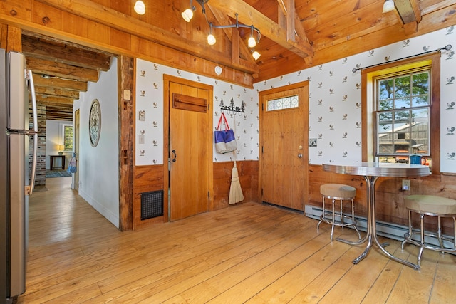 18 Fox Meade Ln, Searsmont, ME 04973 - dining area featuring light wood finished floors, plenty of natural light, a baseboard radiator, wood ceiling, and a wainscoted wall