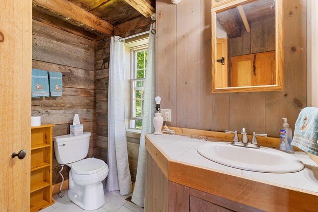18 Fox Meade Ln, Searsmont, ME 04973 - bathroom featuring wooden walls, vanity, toilet, tile patterned floors, and wooden ceiling