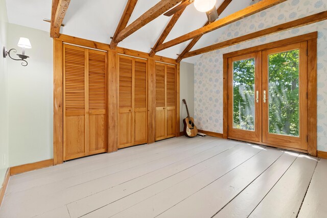 18 Fox Meade Ln, Searsmont, ME 04973 - unfurnished bedroom with wallpapered walls, two closets, and baseboards
