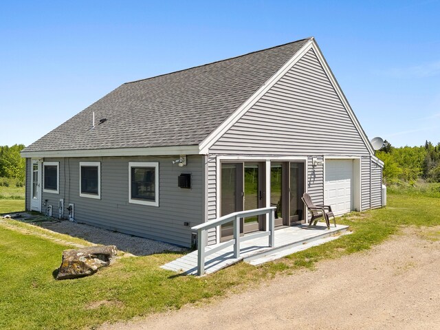 18 Fox Meade Ln, Searsmont, ME 04973 - back of house with roof with shingles, a lawn, and a garage