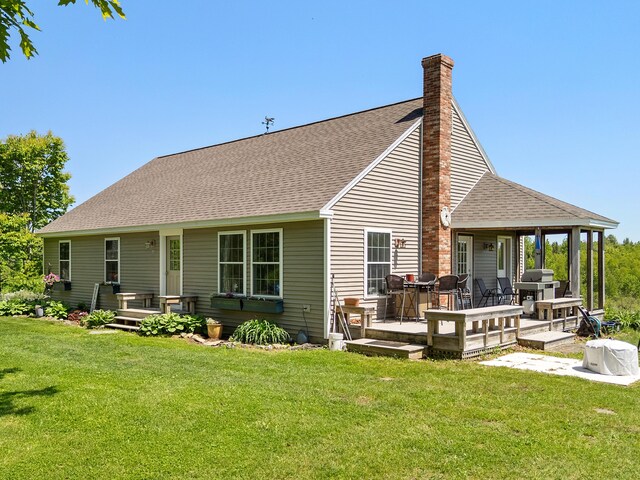 18 Fox Meade Ln, Searsmont, ME 04973 - back of property with a chimney, a lawn, and roof with shingles