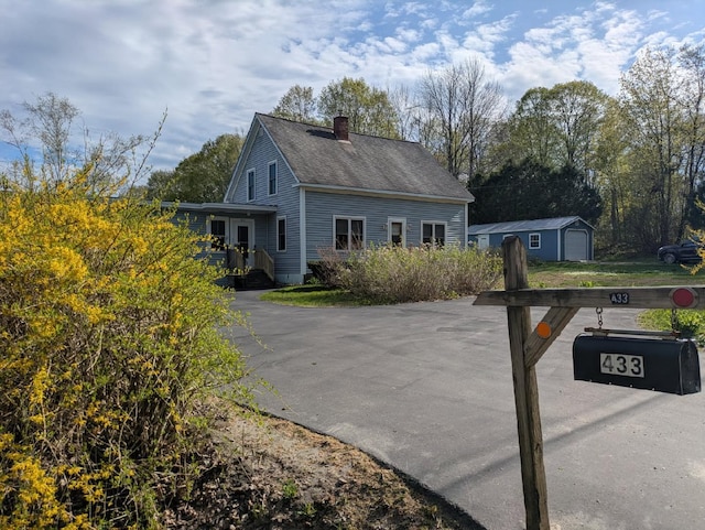 433 Hudson Rd, Corinth, ME 04427 - view of property exterior with a chimney, an outdoor structure, and a shingled roof