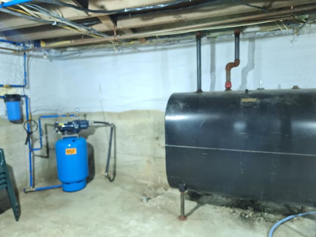 433 Hudson Rd, Corinth, ME 04427 - unfinished below grade area with oil tank and a water pressure tank