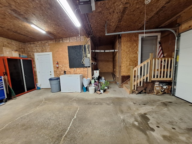 433 Hudson Rd, Corinth, ME 04427 - garage featuring a garage door opener, refrigerator, and electric panel