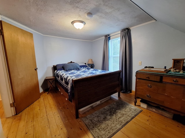 433 Hudson Rd, Corinth, ME 04427 - bedroom featuring light wood-type flooring, crown molding, a textured ceiling, and baseboards