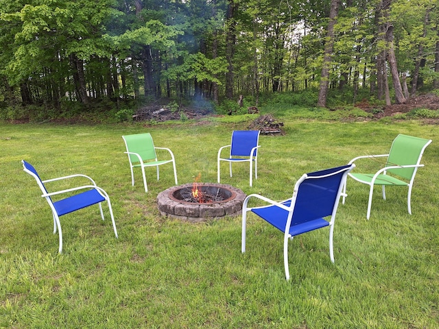 433 Hudson Rd, Corinth, ME 04427 - view of grassy yard featuring an outdoor fire pit