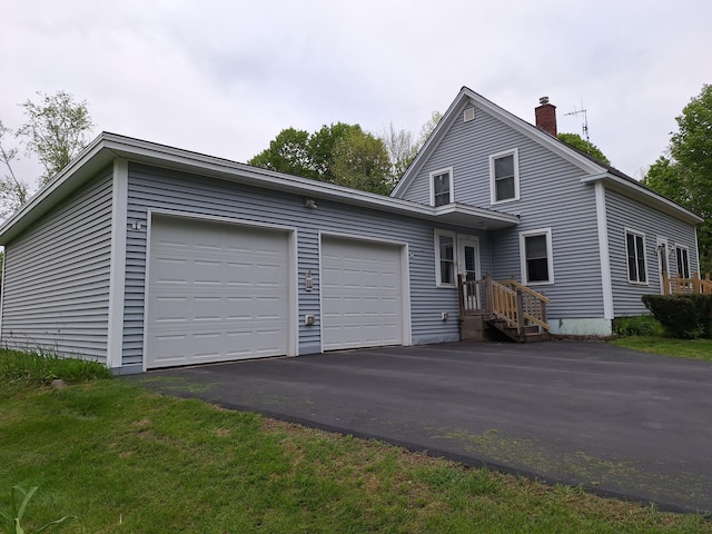 433 Hudson Rd, Corinth, ME 04427 - traditional home featuring a garage, a chimney, and asphalt driveway