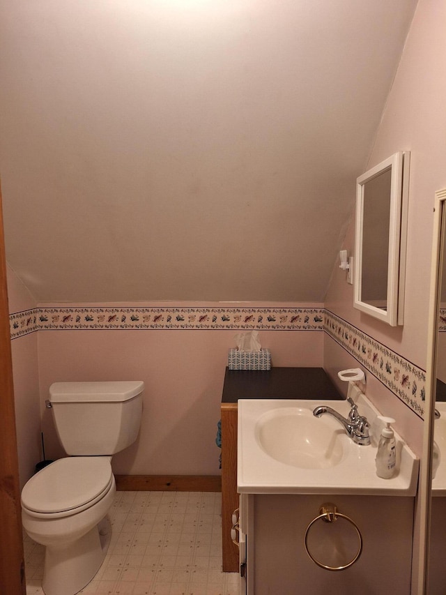 433 Hudson Rd, Corinth, ME 04427 - bathroom featuring tile patterned floors, vanity, lofted ceiling, and toilet
