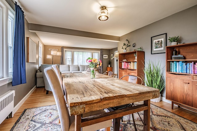 115 Caleb St, Portland, ME 04102 - dining room featuring radiator, light wood-style floors, and baseboards