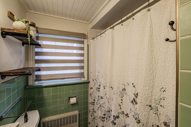 115 Caleb St, Portland, ME 04102 - bathroom with radiator heating unit, a shower with shower curtain, tile walls, and toilet