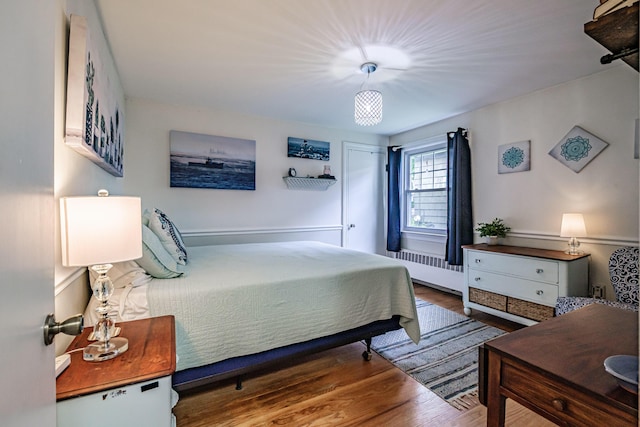 115 Caleb St, Portland, ME 04102 - bedroom with radiator heating unit and wood finished floors
