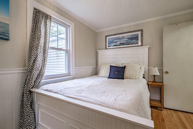 115 Caleb St, Portland, ME 04102 - bedroom featuring light wood finished floors, ornamental molding, and a wainscoted wall