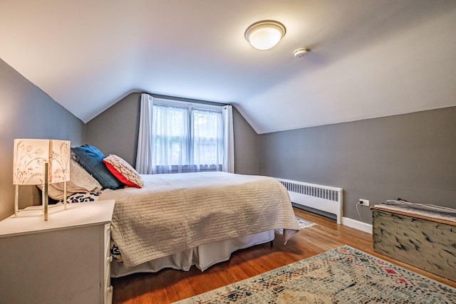 115 Caleb St, Portland, ME 04102 - bedroom with radiator heating unit, wood finished floors, baseboards, and vaulted ceiling