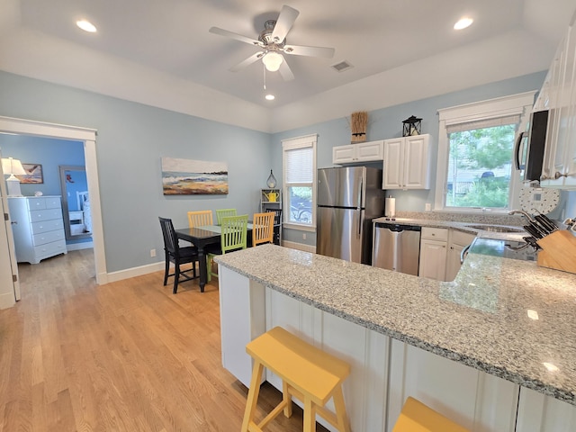 1 Old County Rd Unit 600, Wells, ME 04090 - kitchen featuring appliances with stainless steel finishes, a peninsula, light stone counters, healthy amount of natural light, and recessed lighting