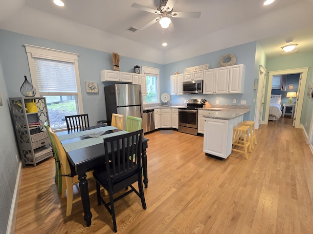 1 Old County Rd Unit 600, Wells, ME 04090 - kitchen with stainless steel appliances, white cabinets, a ceiling fan, plenty of natural light, and recessed lighting