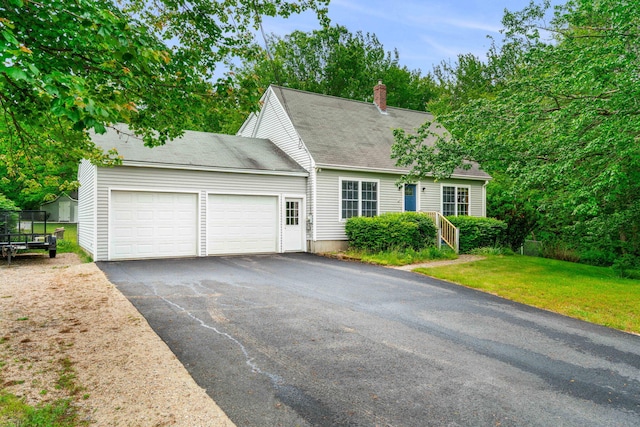 578 Little River Rd, Lebanon, ME 04027 - view of front facade with a garage, driveway, a chimney, and a front yard