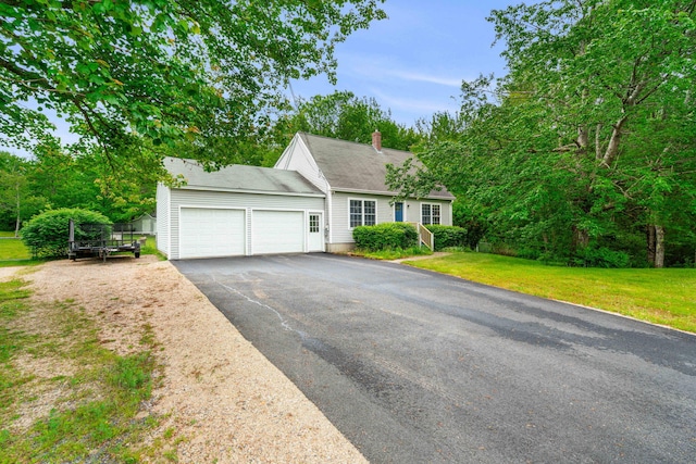 578 Little River Rd, Lebanon, ME 04027 - view of front of property with a garage, a chimney, driveway, and a front yard